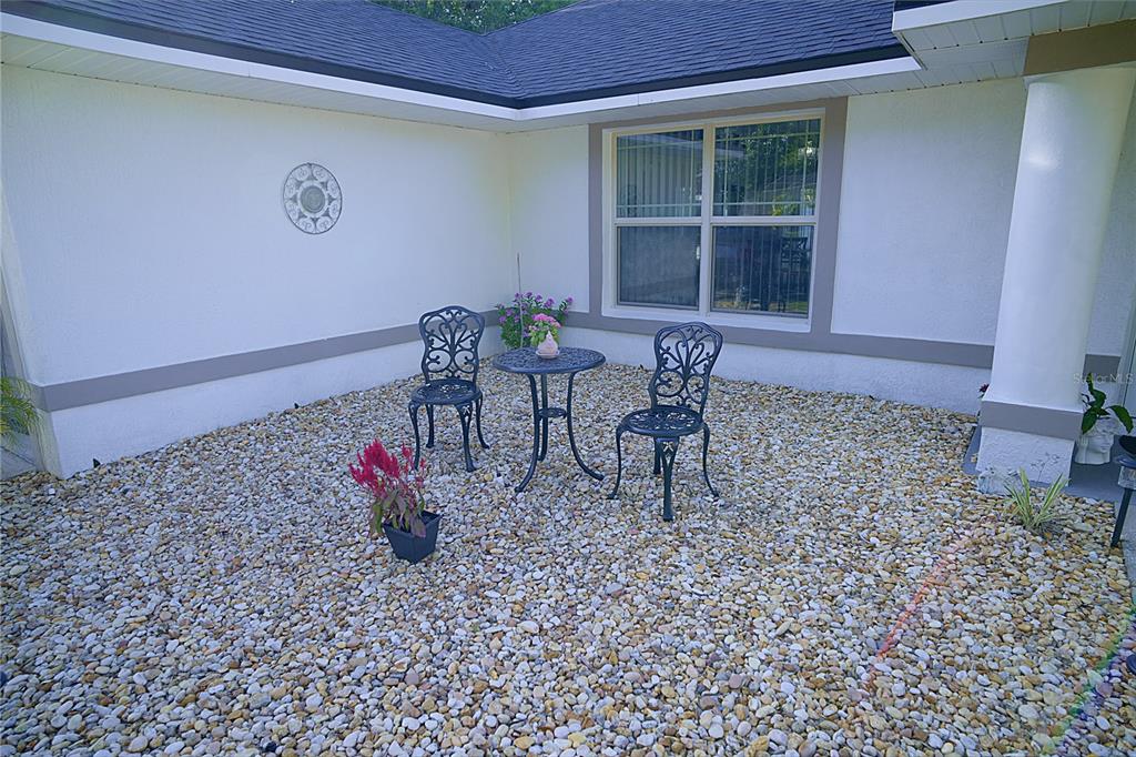 408 Raymond Street Minneola, FL 34715 - Photo 5 of 21 a view of a bench in the patio