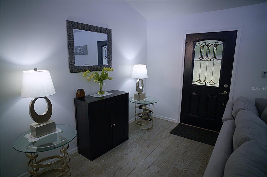 408 Raymond Street Minneola, FL 34715 - Photo 7 of 21 a living room with furniture and a lamp
