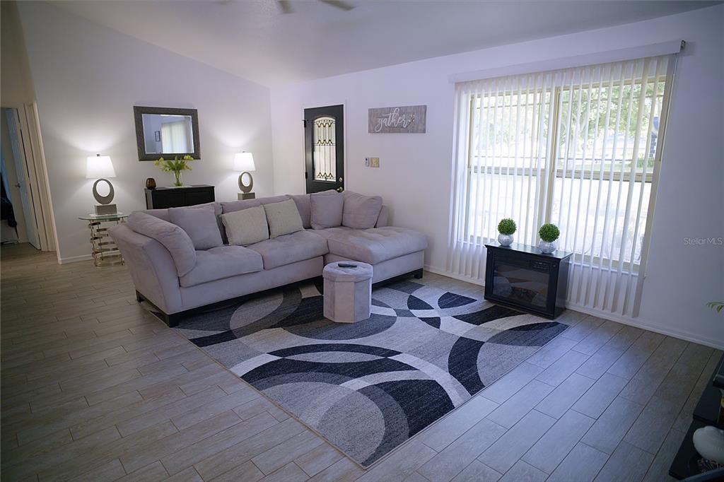 408 Raymond Street Minneola, FL 34715 - Photo 9 of 21 a living room with furniture and wooden floor