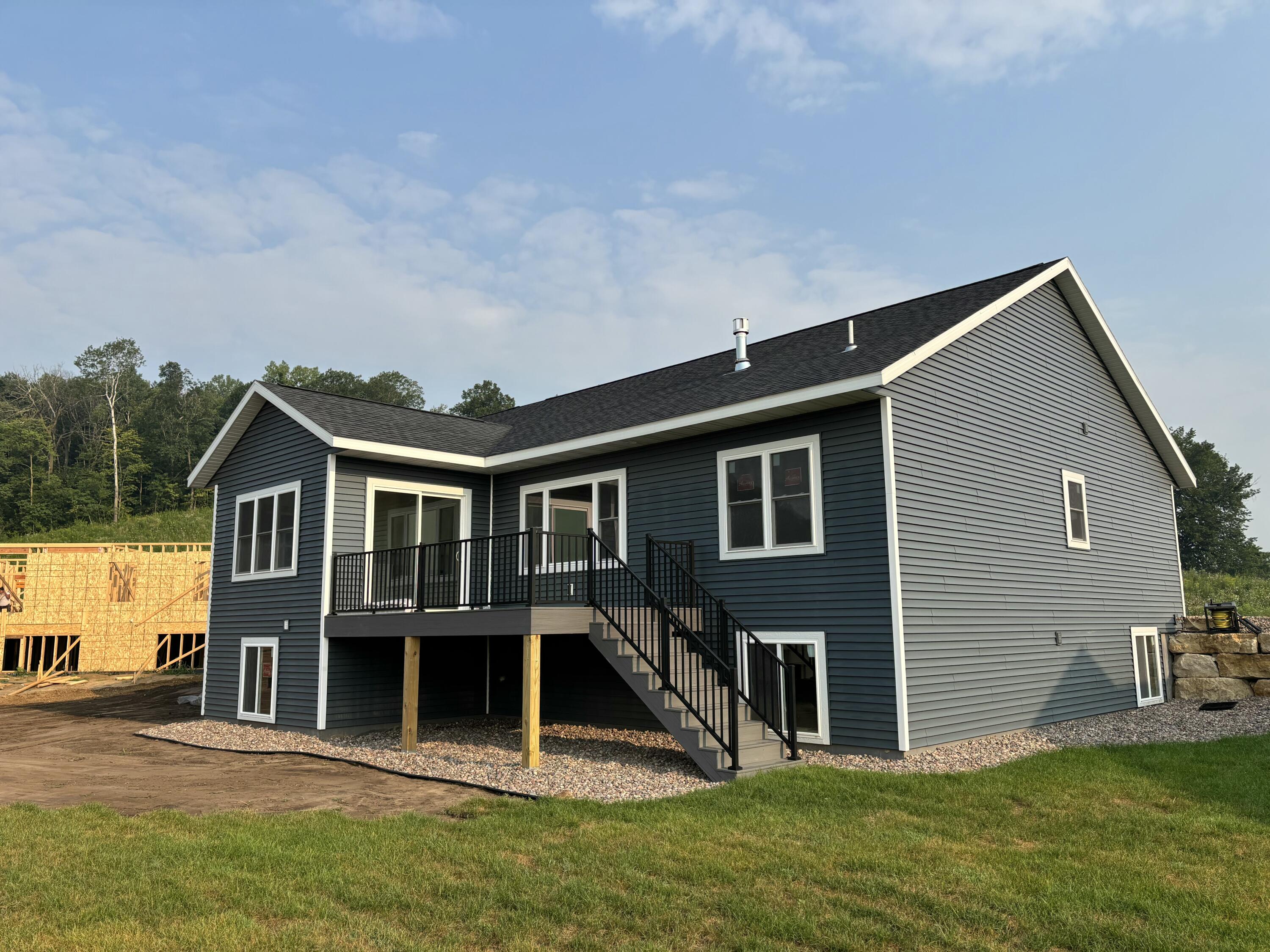 286 Weston Road Holmen, WI 54636 - Photo 7 of 7 Back exterior of 286 Weston Road in Holmen. Patio door in dining room leads to deck with stairs to sod yard.