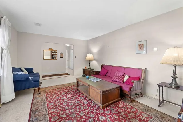 a bedroom with furniture and a lamp