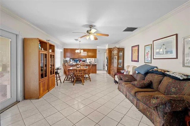 a living room with furniture and a dining table with projector kitchen