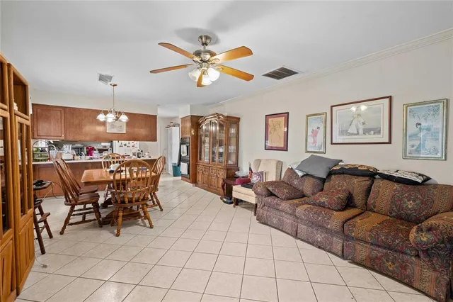 a living room with furniture and kitchen view