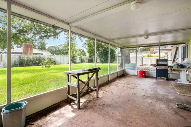 a backyard of a house with outdoor seating and a garden