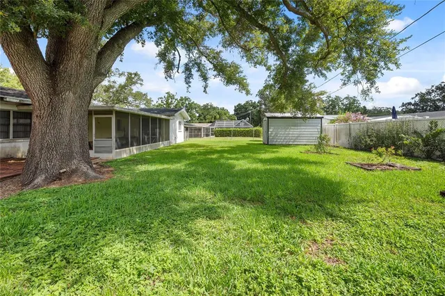 a front view of house with yard and trees