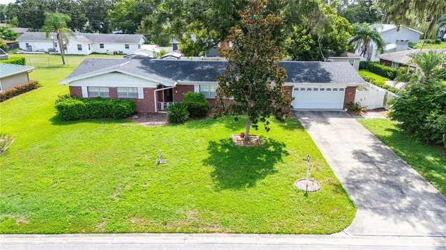 a aerial view of a house with swimming pool garden and patio