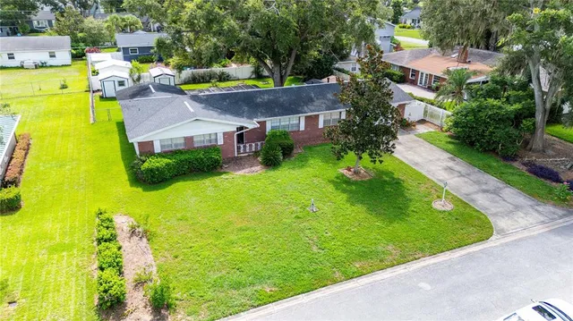 an aerial view of residential houses with yard