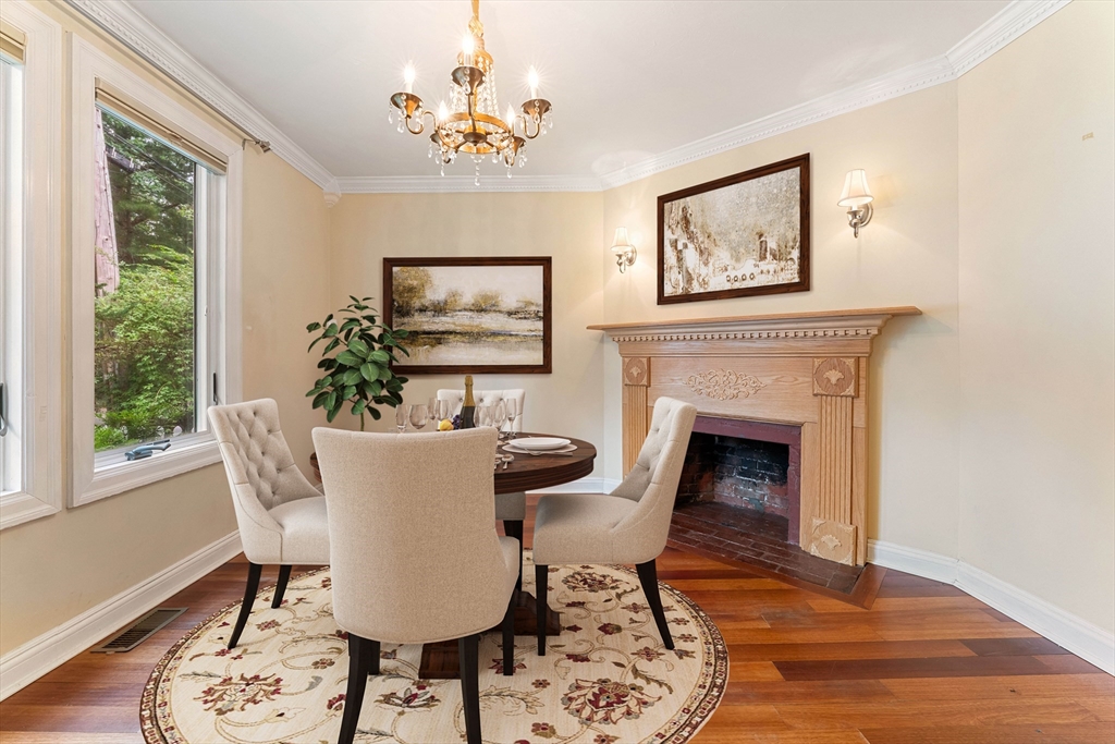 20 Morses Pond Road Natick, MA 01760 - Photo 4 of 15 a dining room with furniture a fireplace and wooden floor