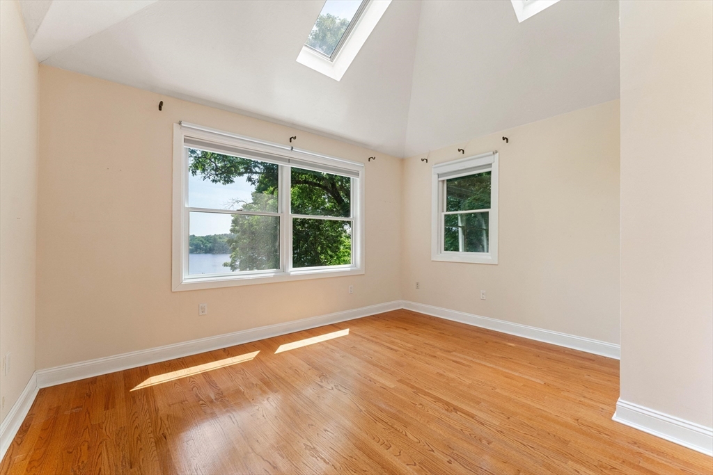 20 Morses Pond Road Natick, MA 01760 - Photo 8 of 15 a view of an empty room with wooden floor and a window