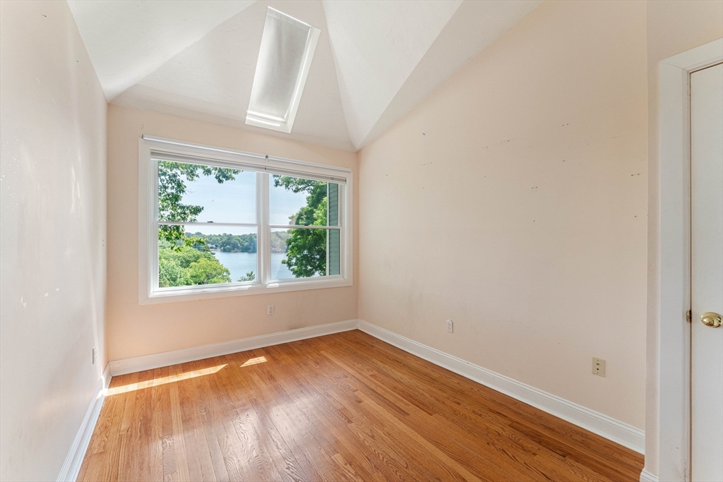 20 Morses Pond Road Natick, MA 01760 - Photo 9 of 15 an empty room with wooden floor and windows