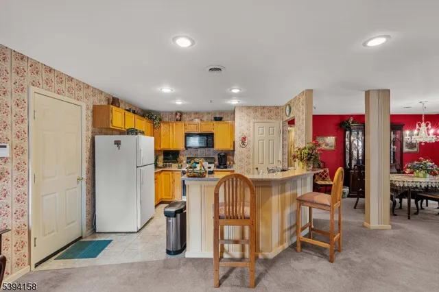 a kitchen with stainless steel appliances kitchen island granite countertop a stove and a sink
