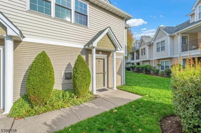 a view of a house with a yard and plants