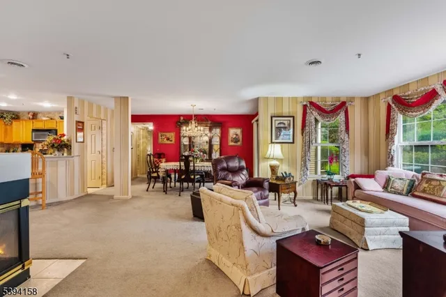 a living room filled with furniture windows and a flat screen tv