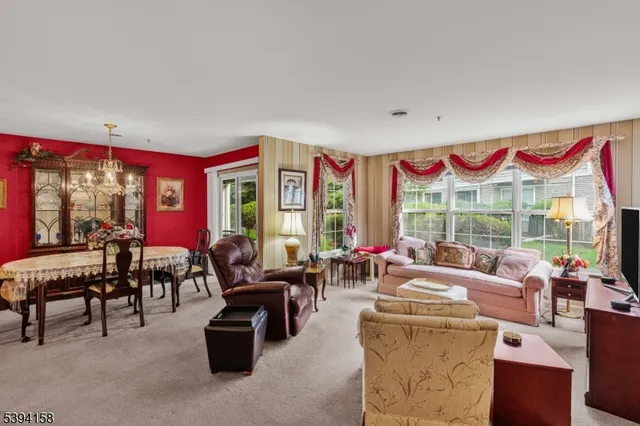 a living room with furniture a fireplace and large windows
