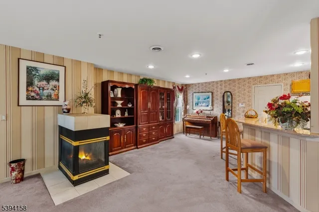 a living room with furniture and a bookshelf