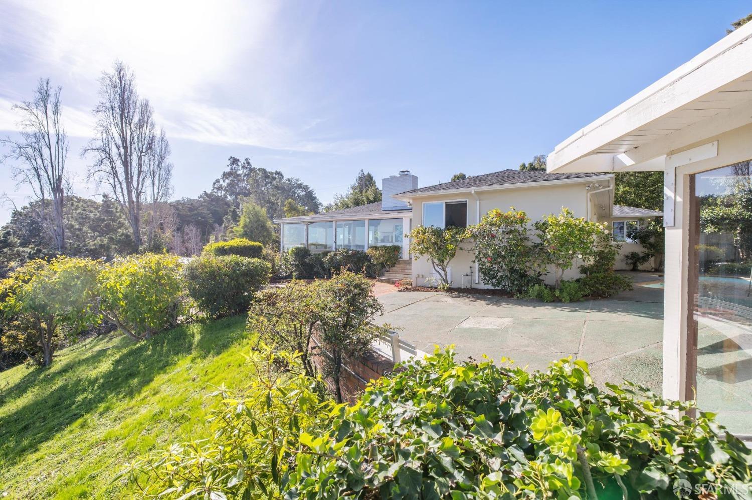 2480 Summit Drive Hillsborough, CA 94010 - Photo 6 of 12 a backyard of a house with a yard and outdoor seating