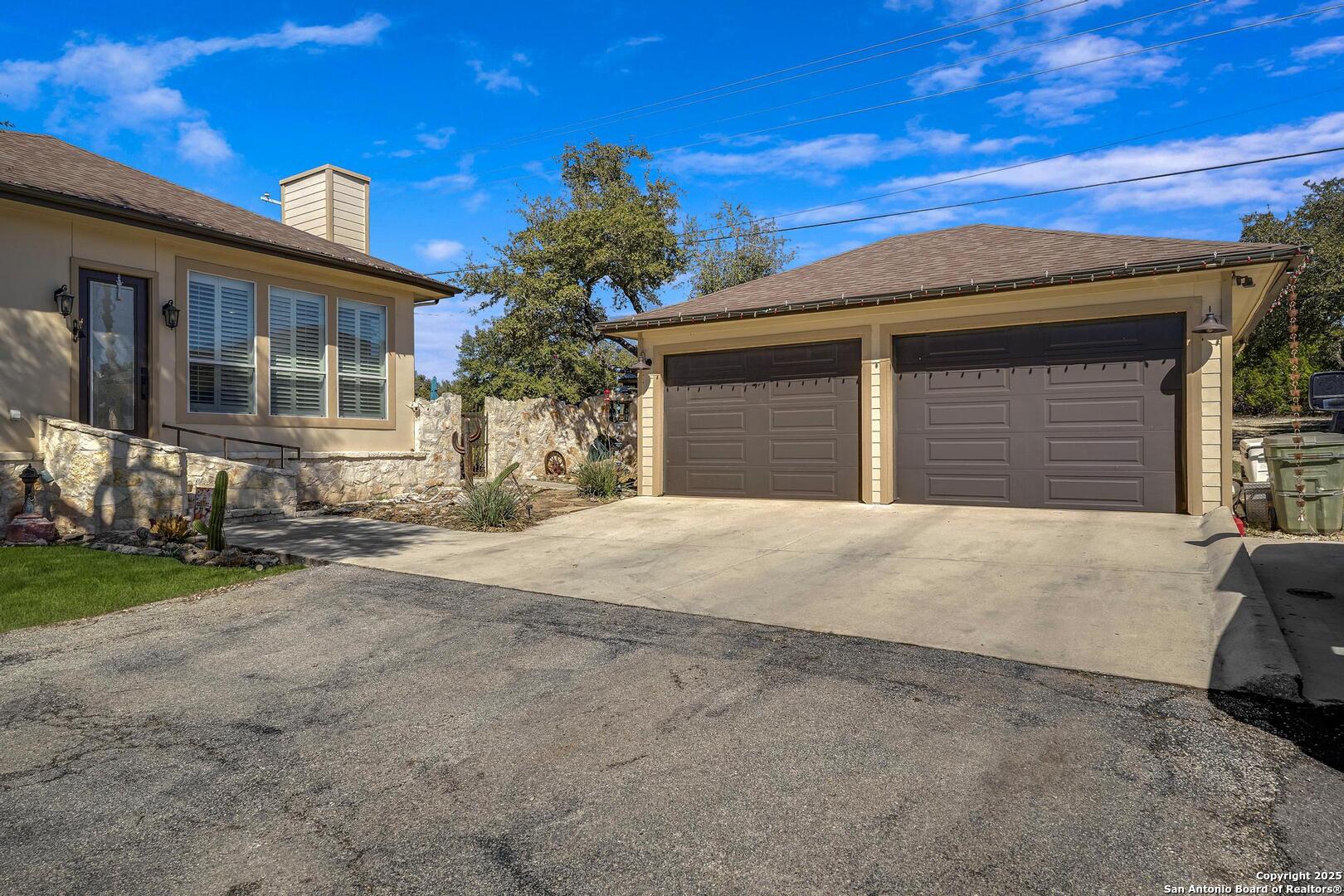 15090 Highway 46 Spring Branch, TX 78070 - Photo 26 of 71 a front view of a house with a yard and garage