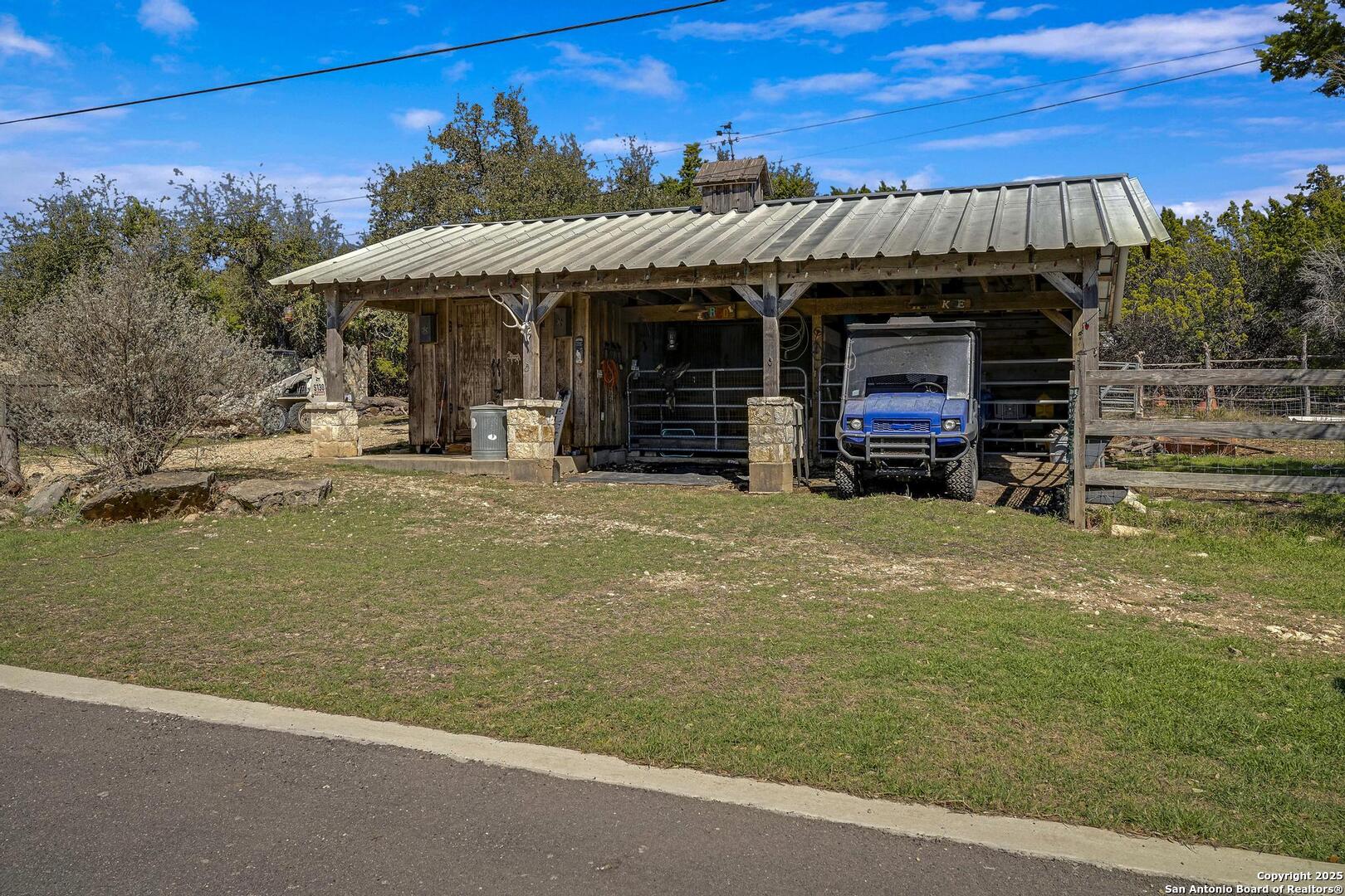 15090 Highway 46 Spring Branch, TX 78070 - Photo 27 of 71 a view of a house with a patio and a fireplace