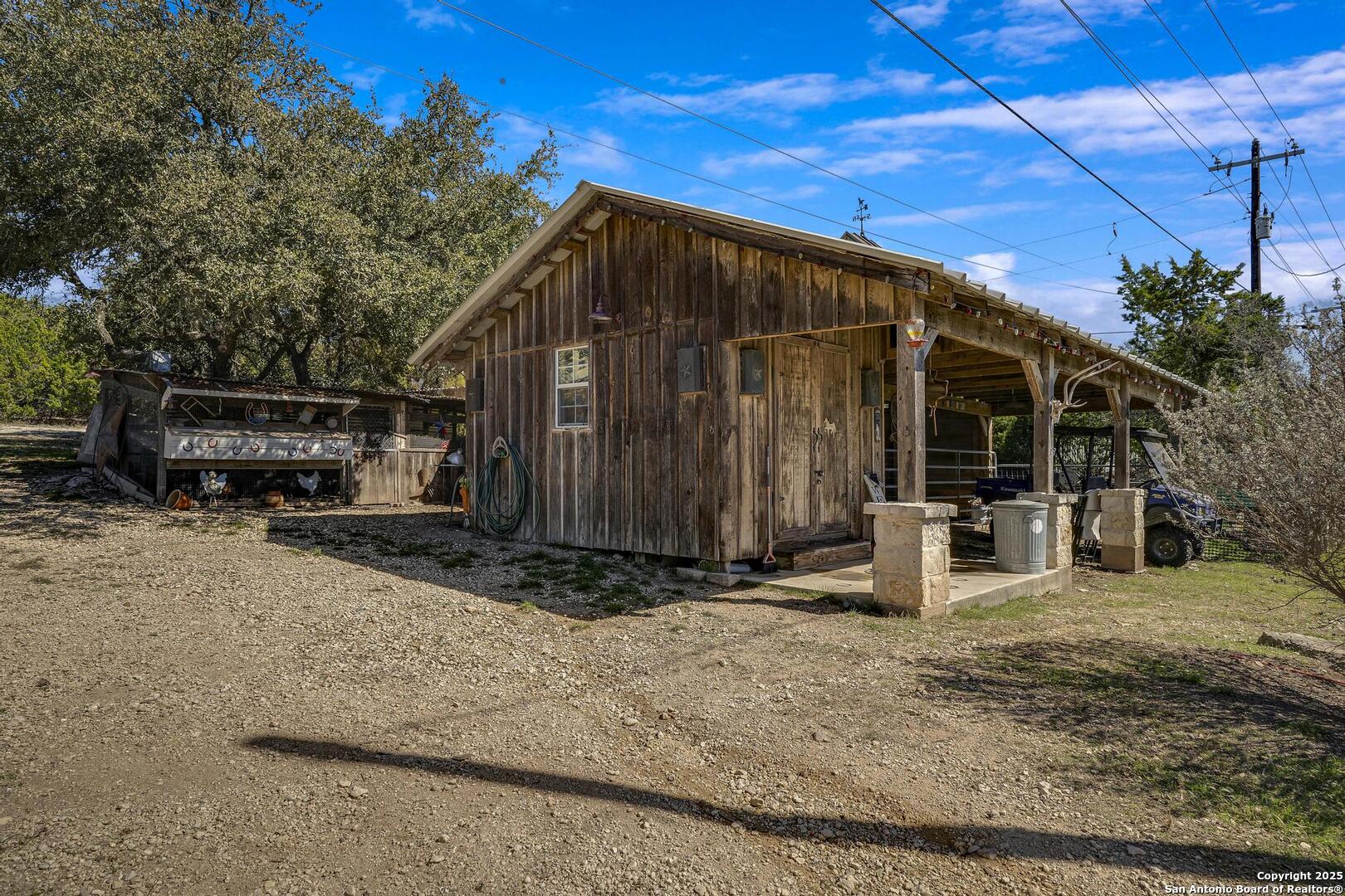 15090 Highway 46 Spring Branch, TX 78070 - Photo 28 of 71 a backyard of a house with barbeque oven and outdoor seating