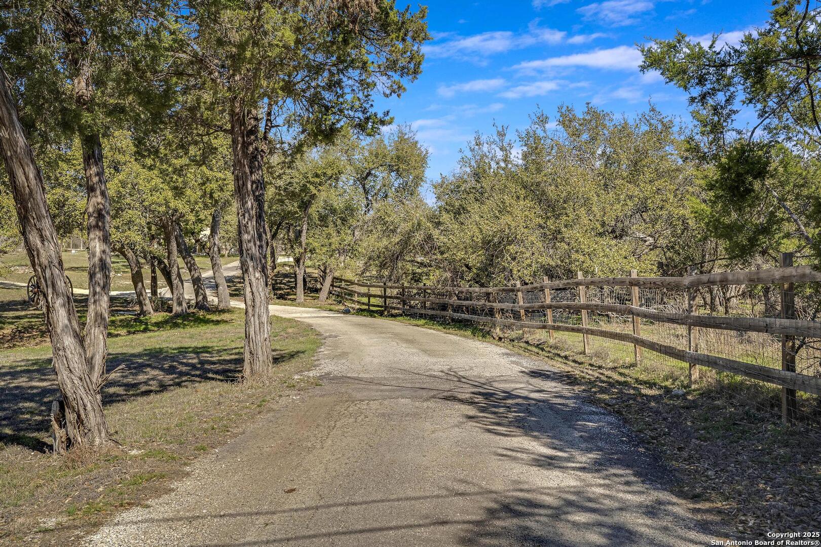15090 Highway 46 Spring Branch, TX 78070 - Photo 34 of 71 a view of a yard with wooden fence