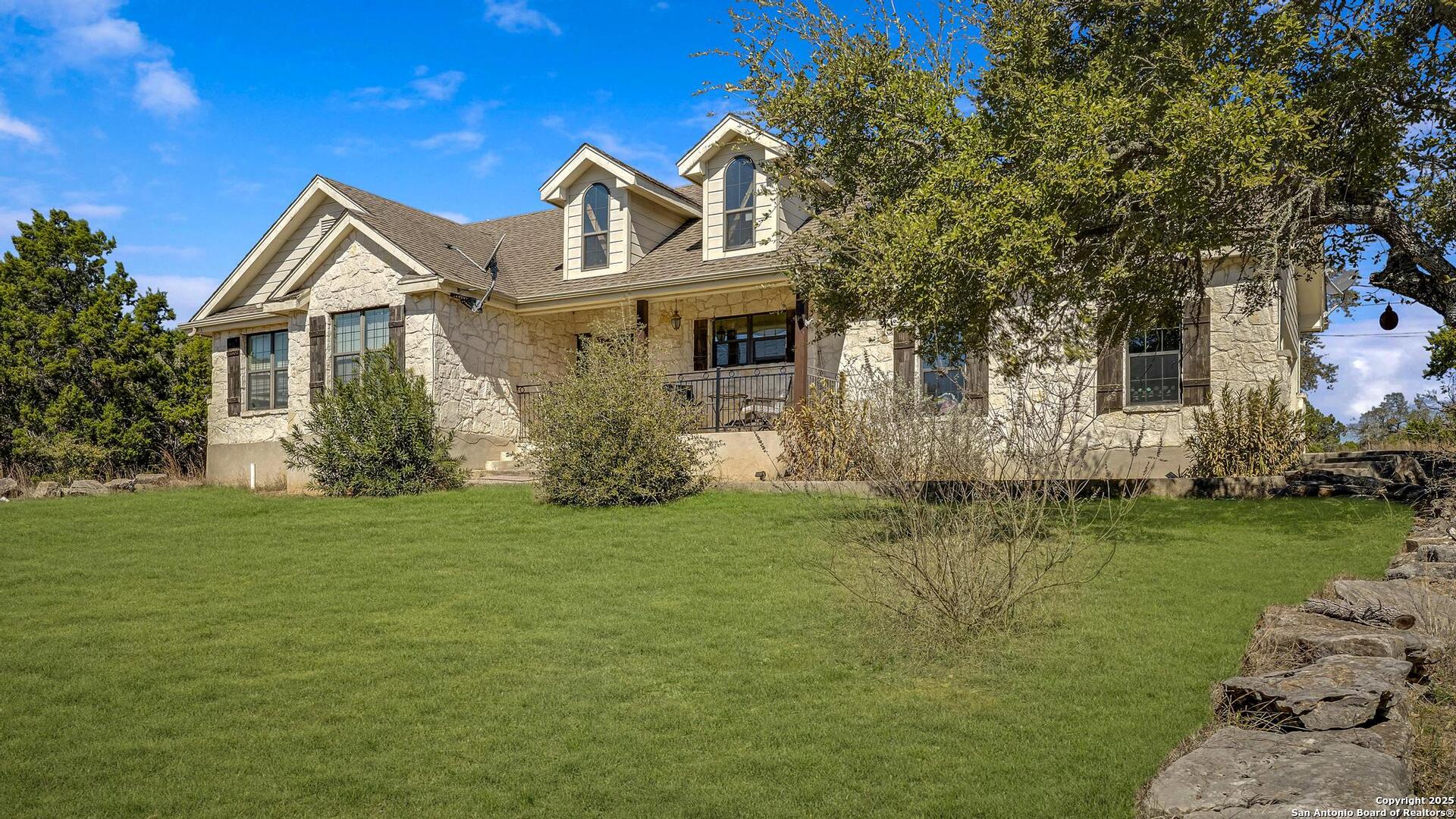 15090 Highway 46 Spring Branch, TX 78070 - Photo 38 of 71 a front view of a house with a garden