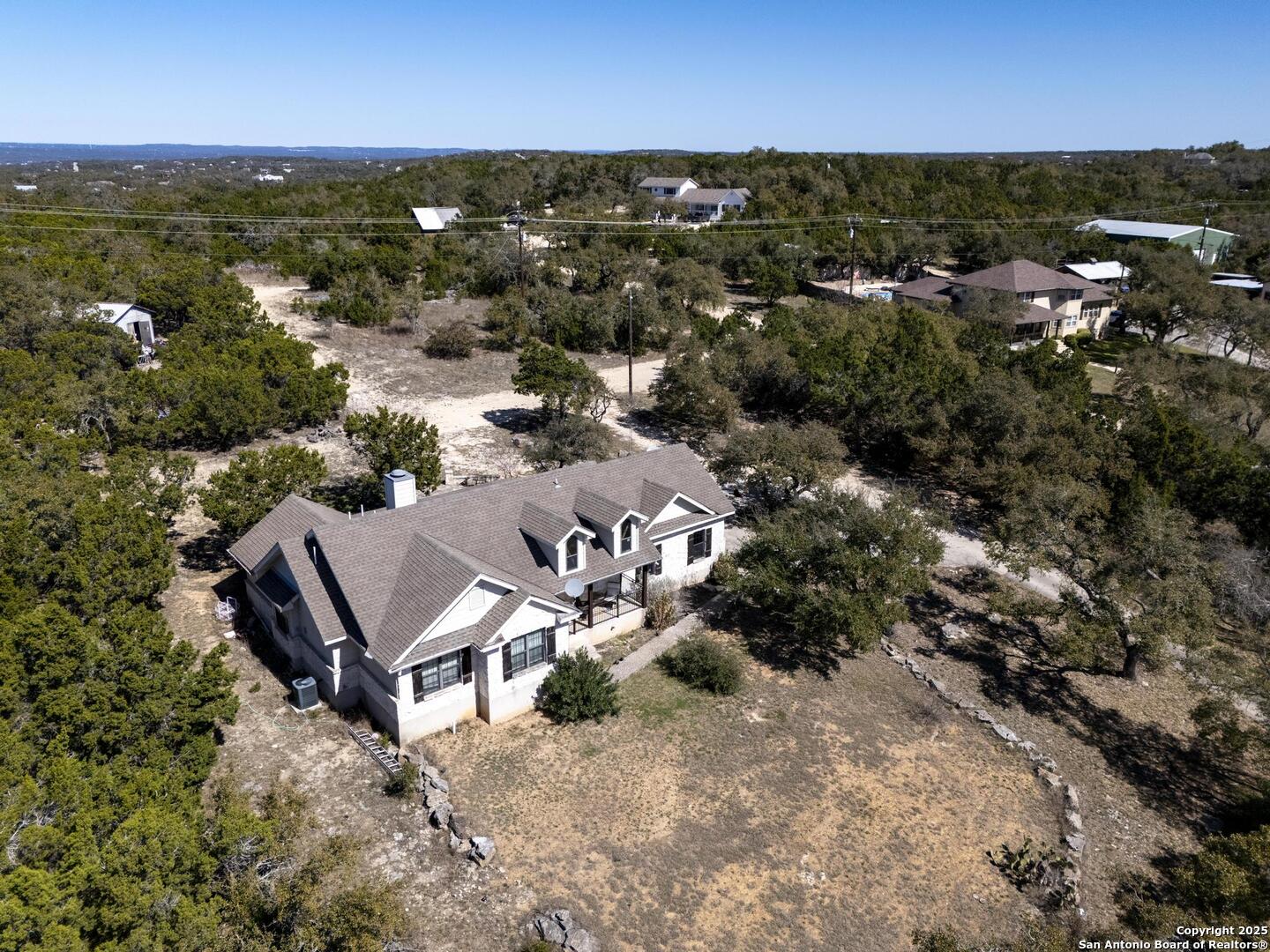 15090 Highway 46 Spring Branch, TX 78070 - Photo 66 of 71 an aerial view of a houses with a yard and lake view