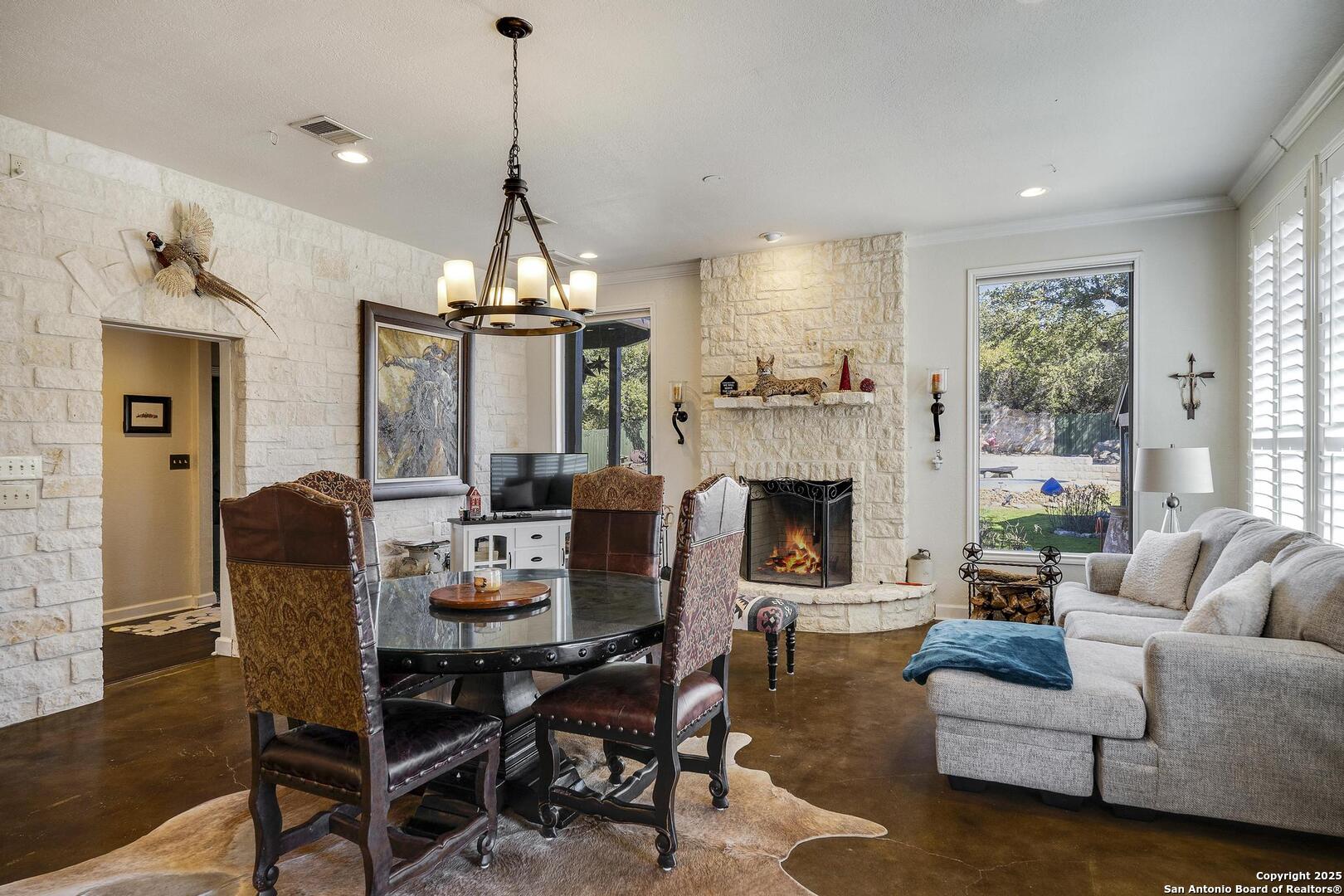 15090 Highway 46 Spring Branch, TX 78070 - Photo 10 of 71 a living room with furniture a fireplace and a chandelier