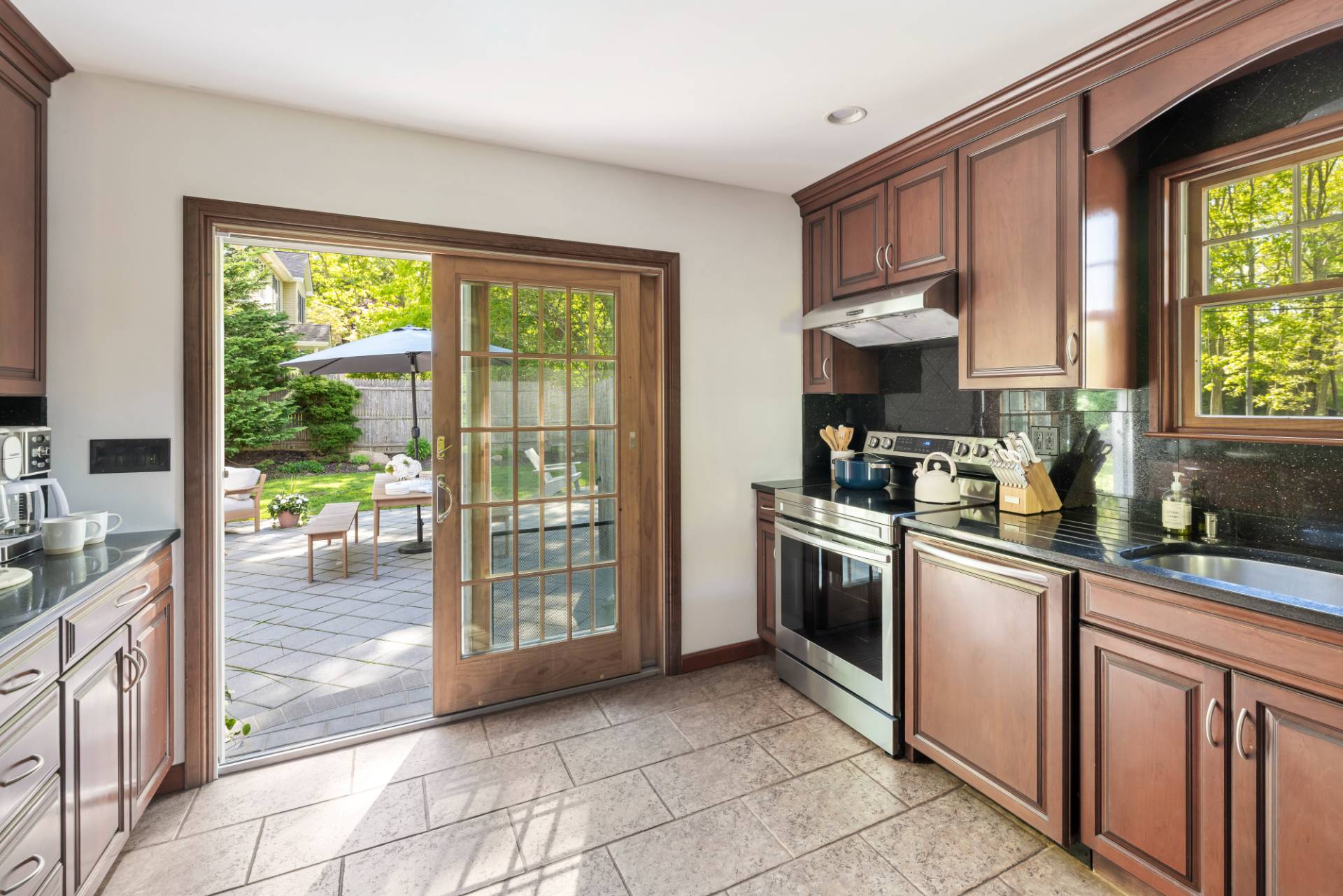 40 Ridge Road West Sag Harbor, NY 11963 - Photo 11 of 27 a kitchen with stainless steel appliances granite countertop a stove a sink and a refrigerator