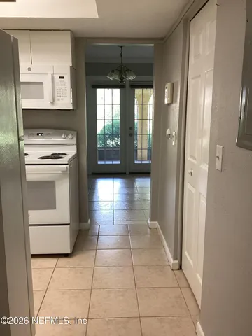 a kitchen with stainless steel appliances a stove a refrigerator and a cabinets