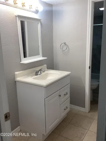 a bathroom with a sink vanity and mirror