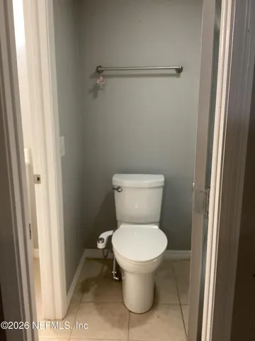 a white toilet sitting next to a shower