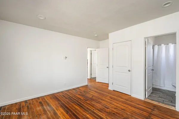 a view of a room with wooden floor and bathroom