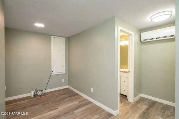 a view of room with window and wooden floor