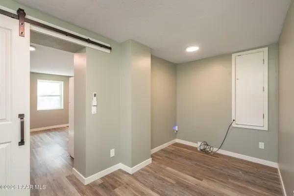 a view of empty room with wooden floor