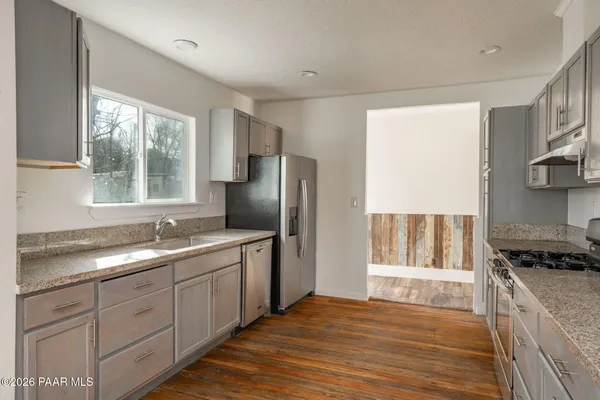 a kitchen with a sink stove and refrigerator
