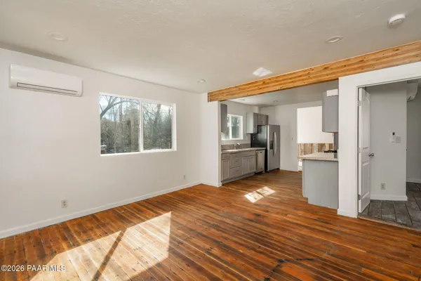 a view of kitchen and hall with wooden floor