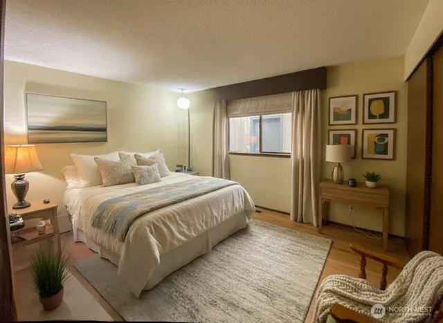 a bedroom with a large bed and a window