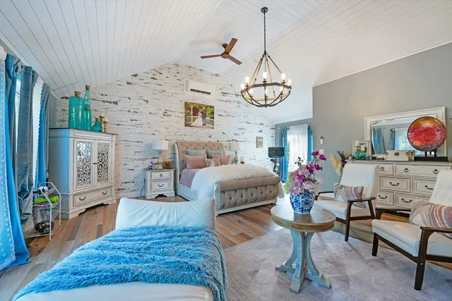 a living room with furniture chandelier and a fireplace