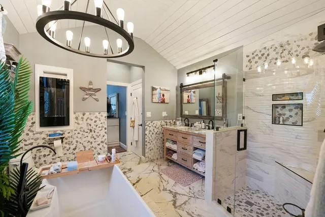 a spacious bathroom with a double vanity sink a mirror a bathtub and shower