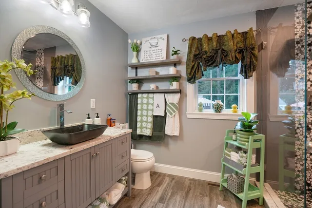 a bathroom with a sink a toilet and a mirror