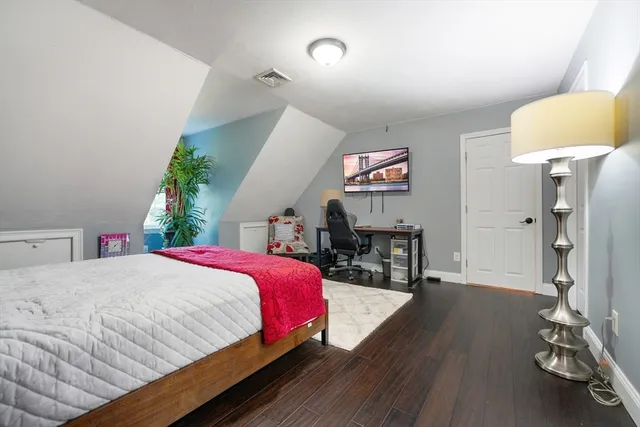 a bedroom with a bed and a table in it