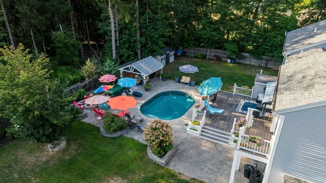 a view of a chairs and table in backyard