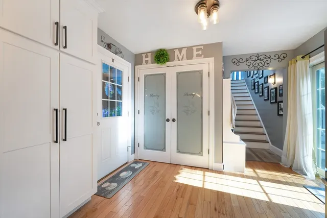 a view of a hallway with wooden floor and staircase