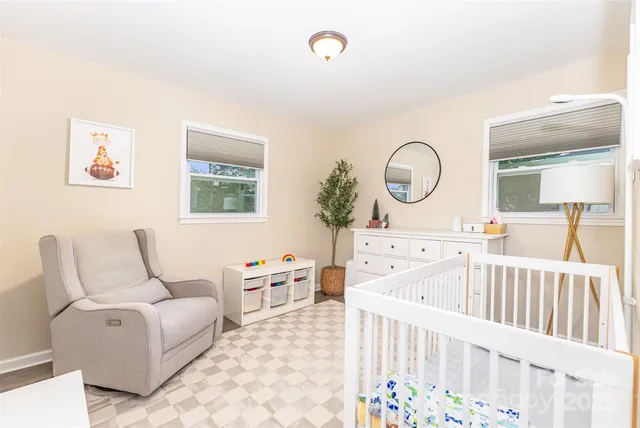 a bedroom with furniture and a wooden floor