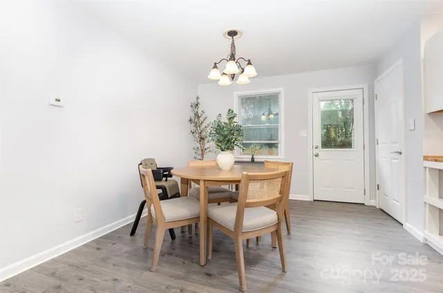 a dining room with furniture a chandelier and a rug