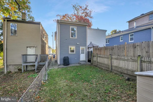 a view of a house with a yard and sitting area
