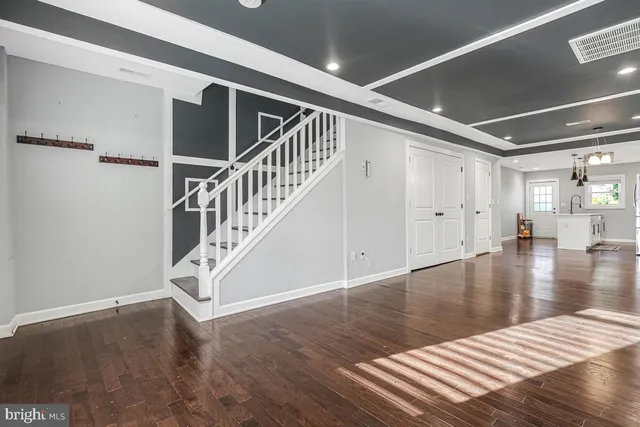 a view of a room with wooden floor and staircase