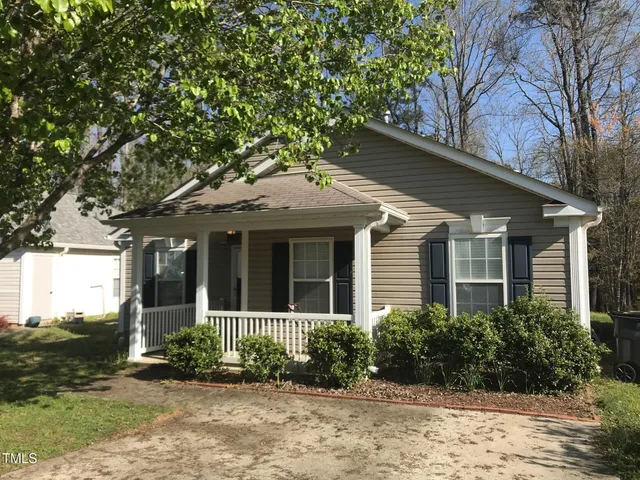 front view of a house with a garden