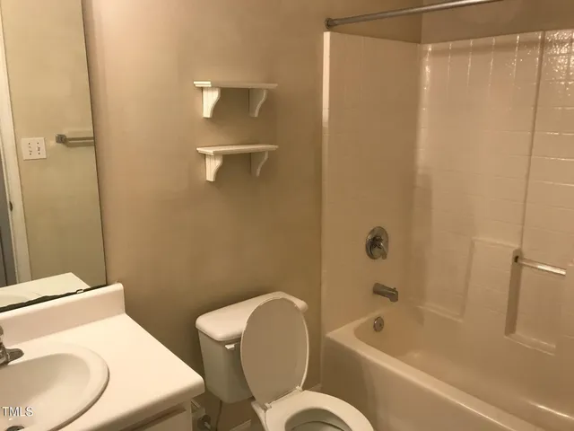 a bathroom with a toilet and a bathtub