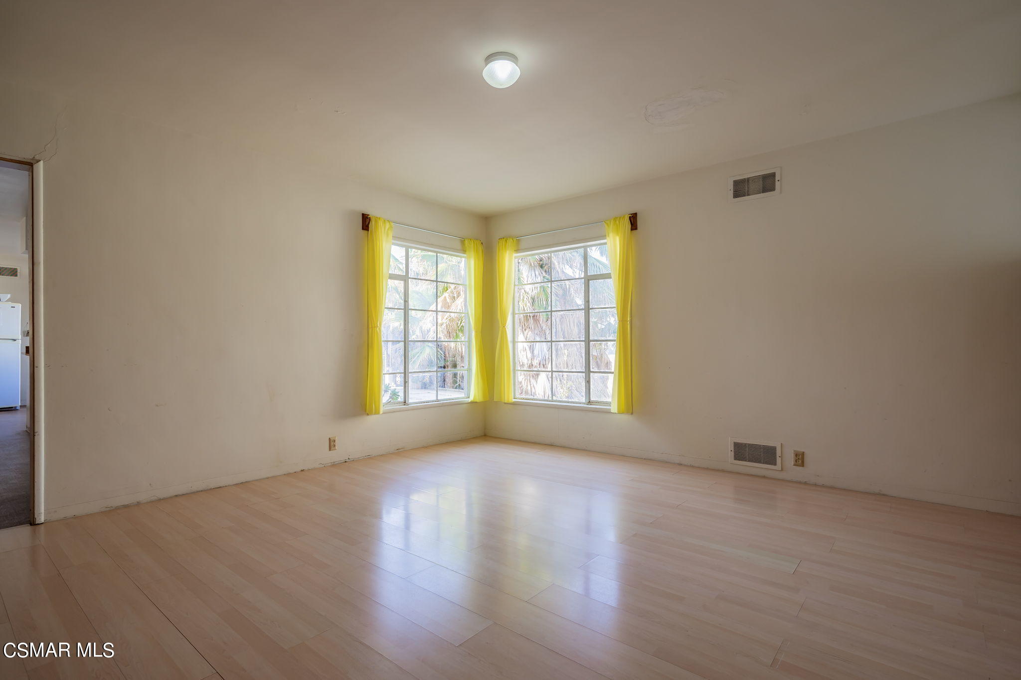 10901 Darling Road Ventura, CA 93004 - Photo 14 of 68 an empty room with wooden floor and windows